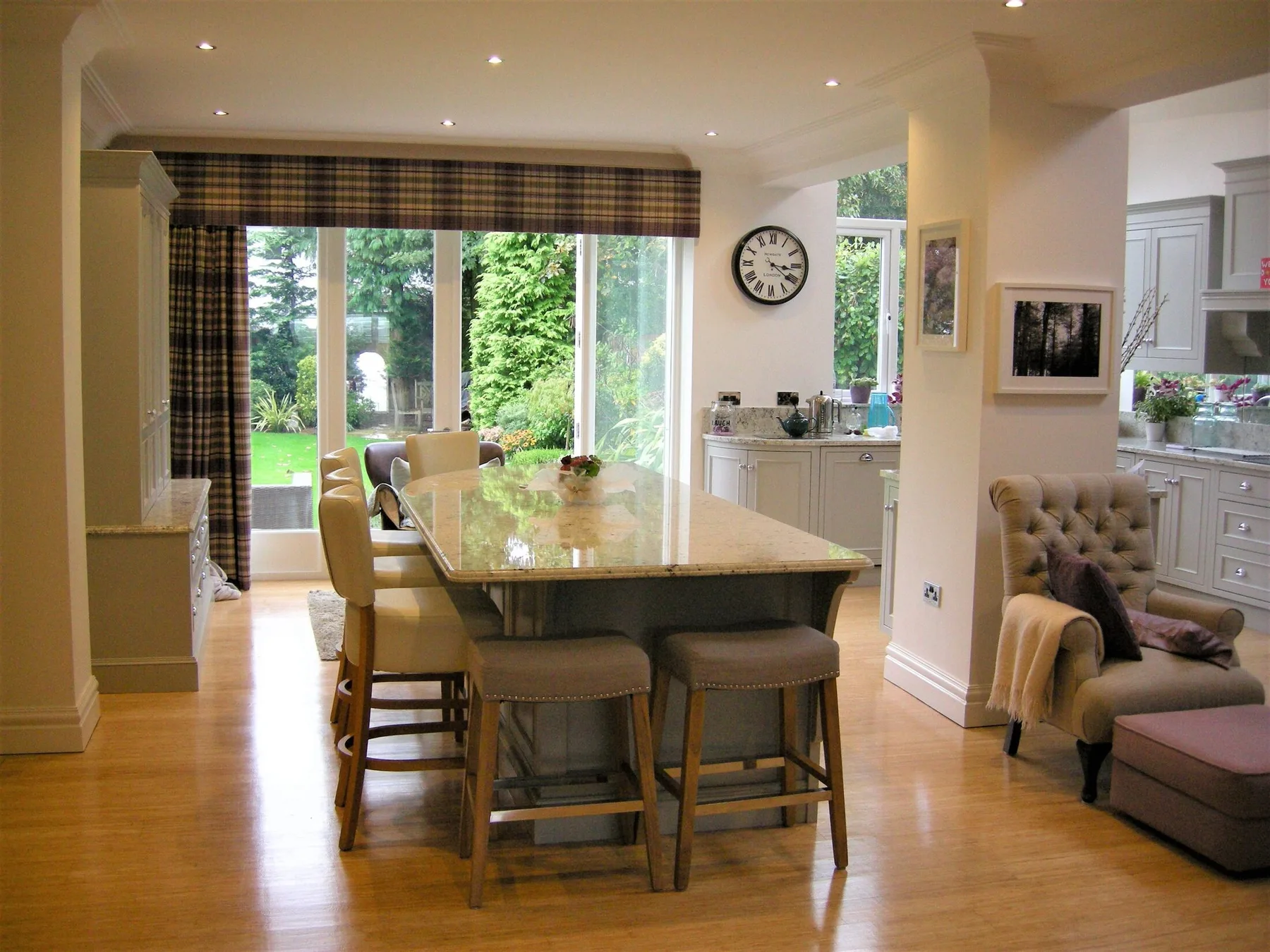 A curved timber kitchen island in an open-plan Corinthian kitchen