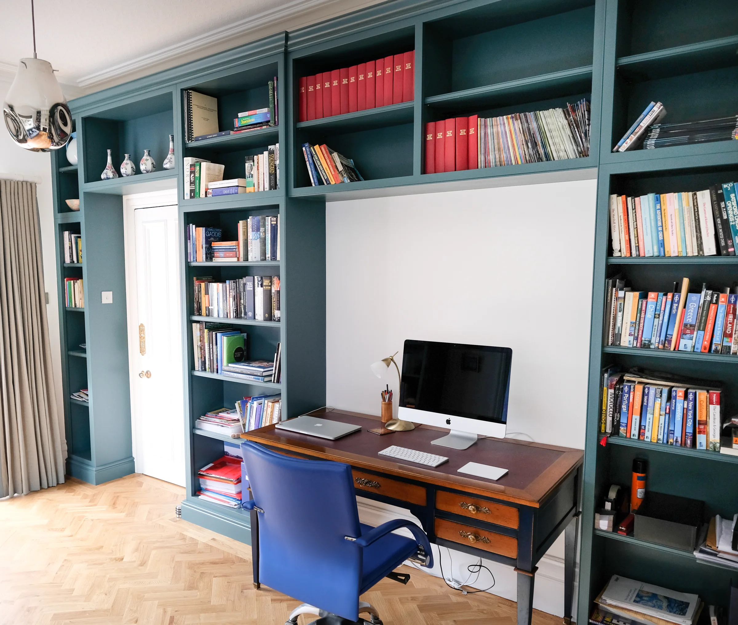 A green fitted study arranged around a desk and doorway